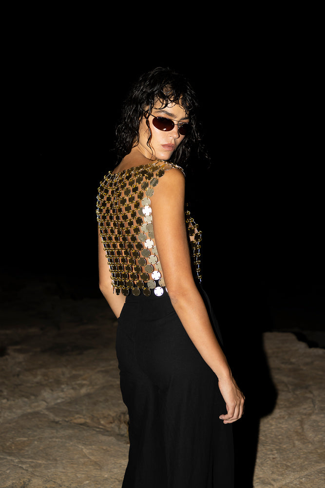gold chainmail boat neck top, luxurious handcrafted metal texture.