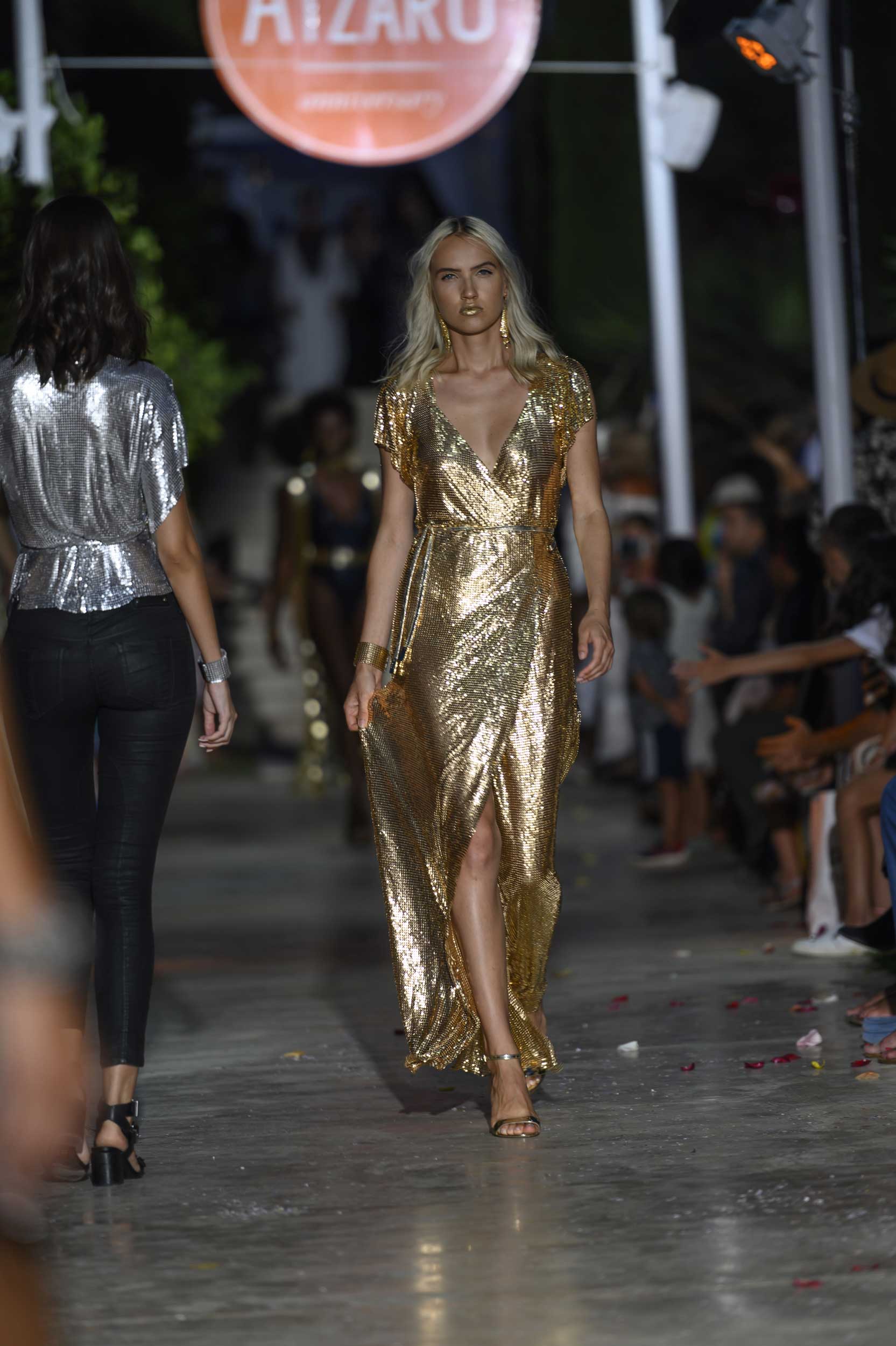 Floor-length gold chainmail maxi dress with smooth metallic finish, a show-stopping statement gown